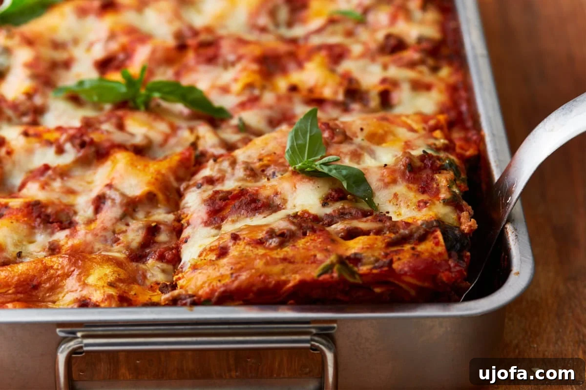 Irresistible Gluten-Free Lasagna 14 A perfectly cooked gluten-free lasagna, garnished with fresh basil, with one slice carefully cut and ready to be served from the tin baking dish.