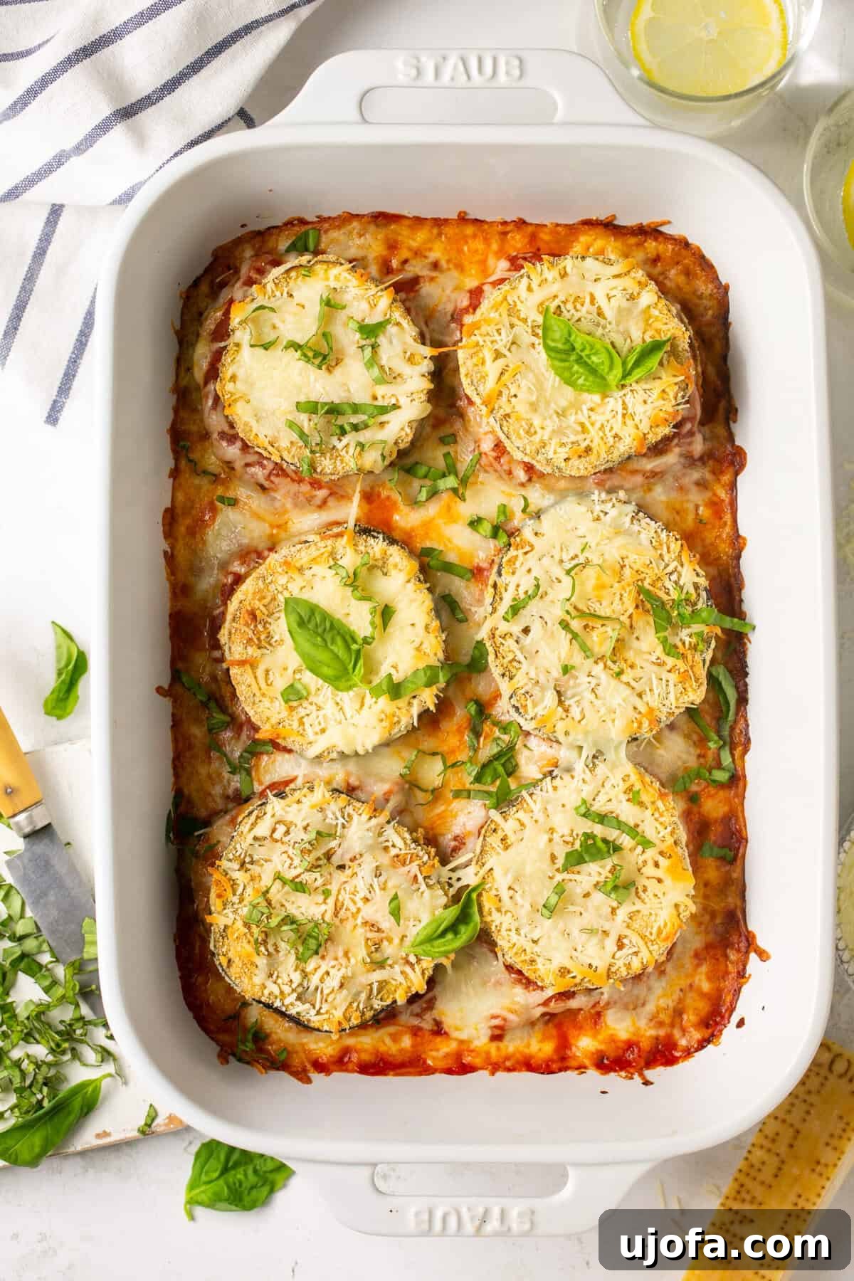 Keto Baked Eggplant Parmesan in a white Staub casserole dish