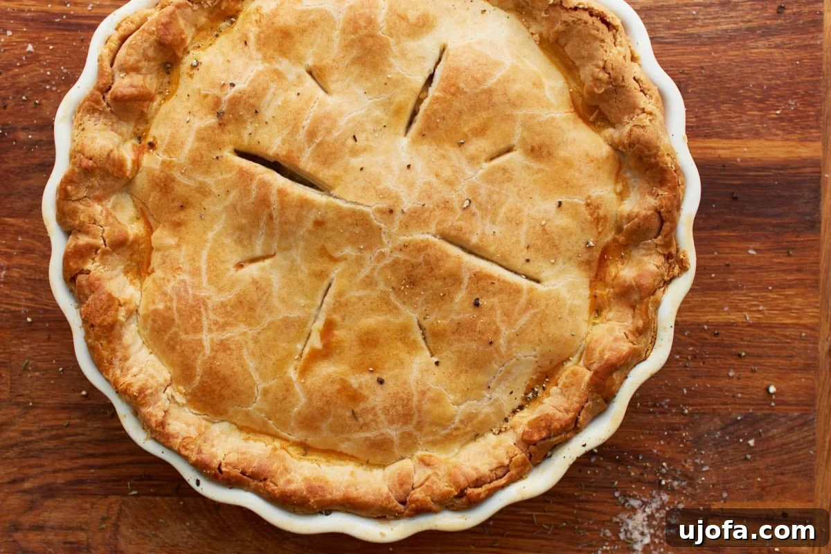 The Ultimate Gluten-Free Chicken Pot Pie 16 cooked gluten-free chicken pot pie in a white baking dish on a wooden counter