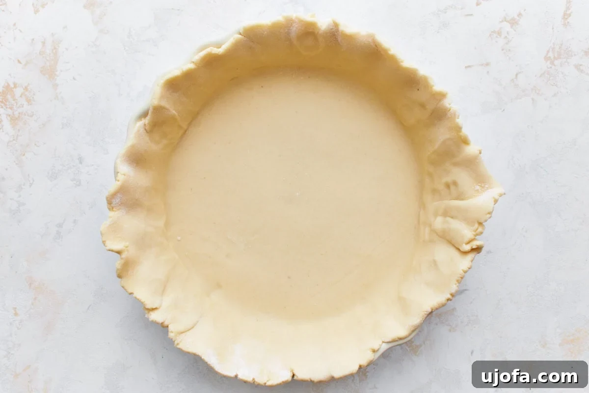 The Ultimate Gluten-Free Chicken Pot Pie 8 gluten-free pie crust formed into a pie dish sitting on a light countertop