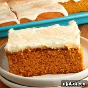 Decadent Gluten-Free Pumpkin Spice Squares 5 Gluten-free pumpkin bars with cream cheese frosting on a white plate with the pan of bars in the background