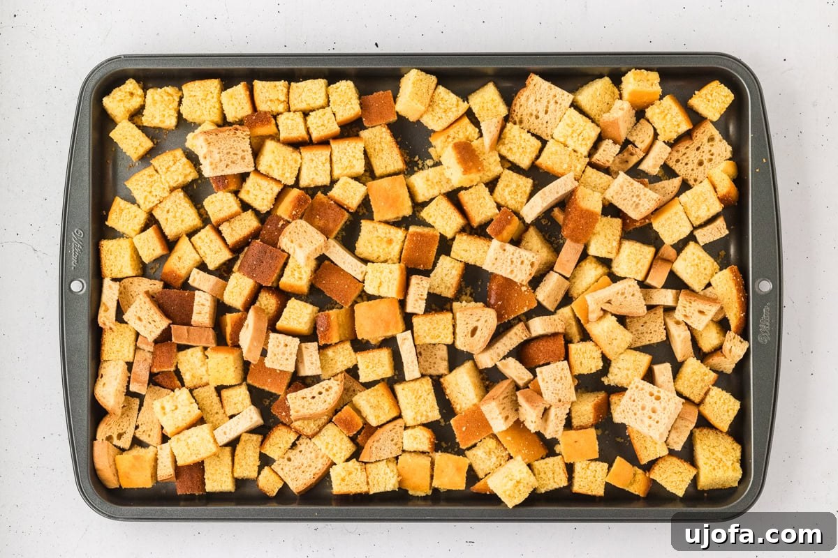 Savory Gluten-Free Cornbread Dressing 11 A baking sheet filled with evenly cubed, dried gluten-free cornbread and gluten-free bread, ready for the stuffing assembly.