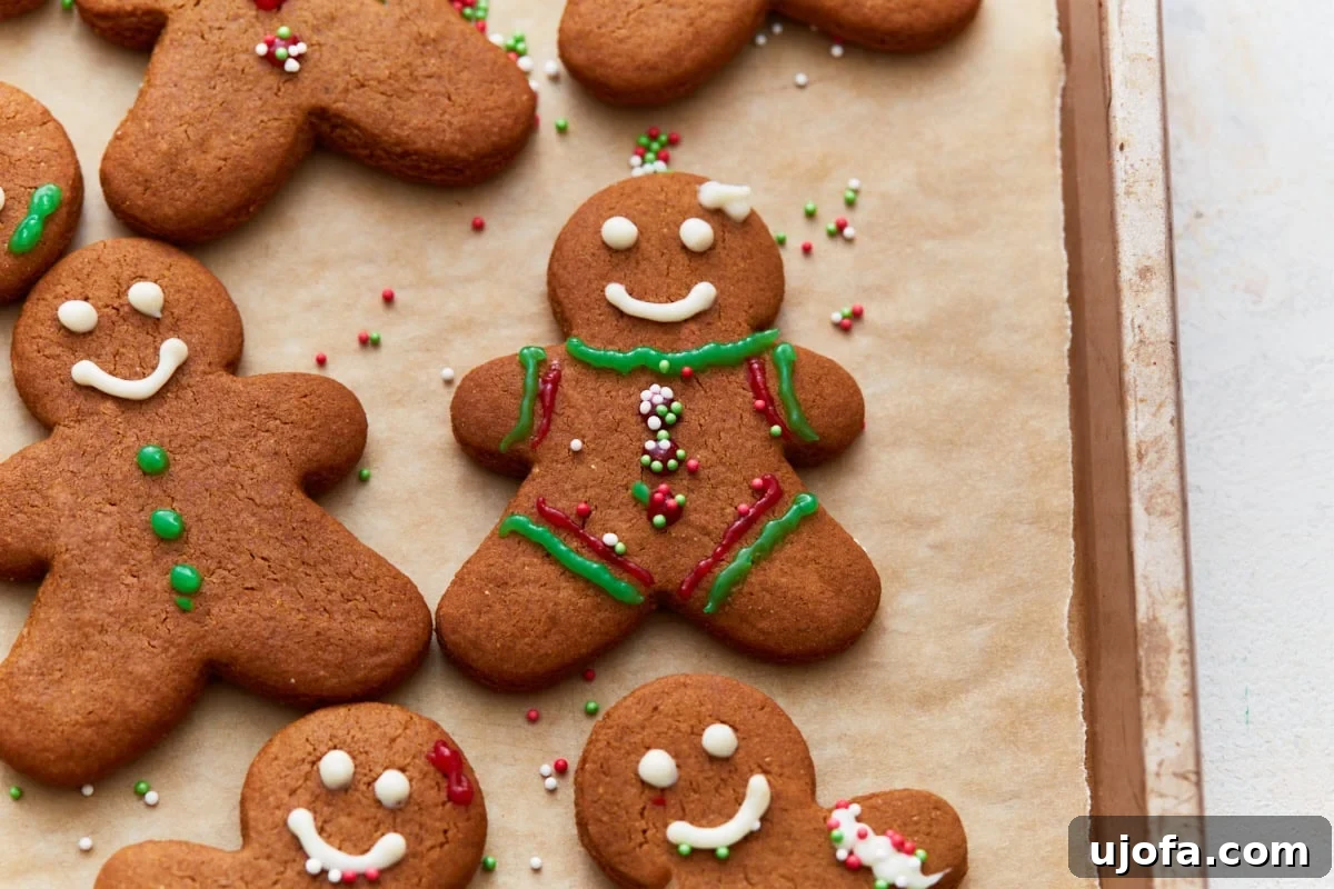 Guilt-Free Gingerbread Bliss 4 A top-down photo of several meticulously decorated gluten-free gingerbread cookies adorned with colorful sprinkles and icing, arranged artistically for a festive display.