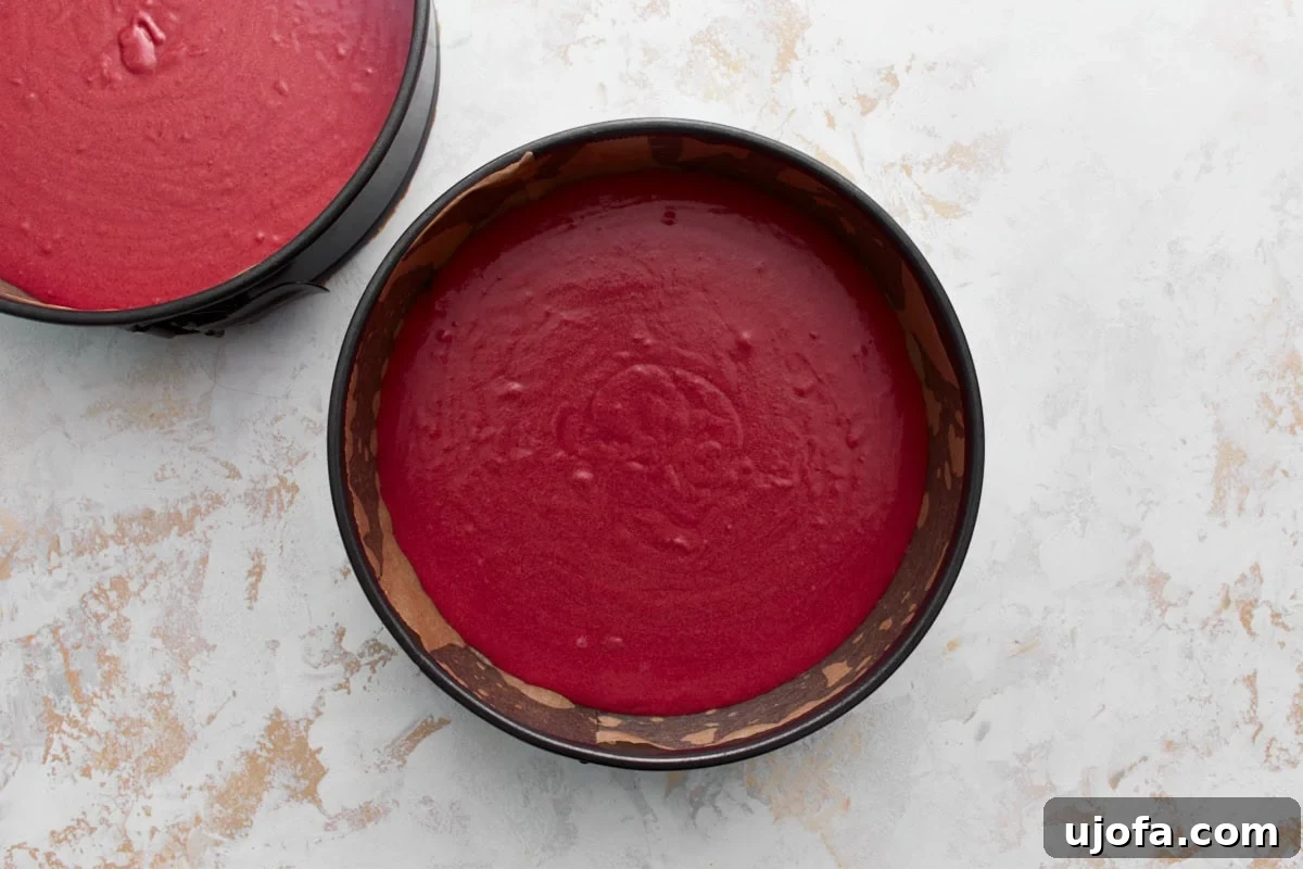 two cake pans with gluten-free red velvet cake batter in them