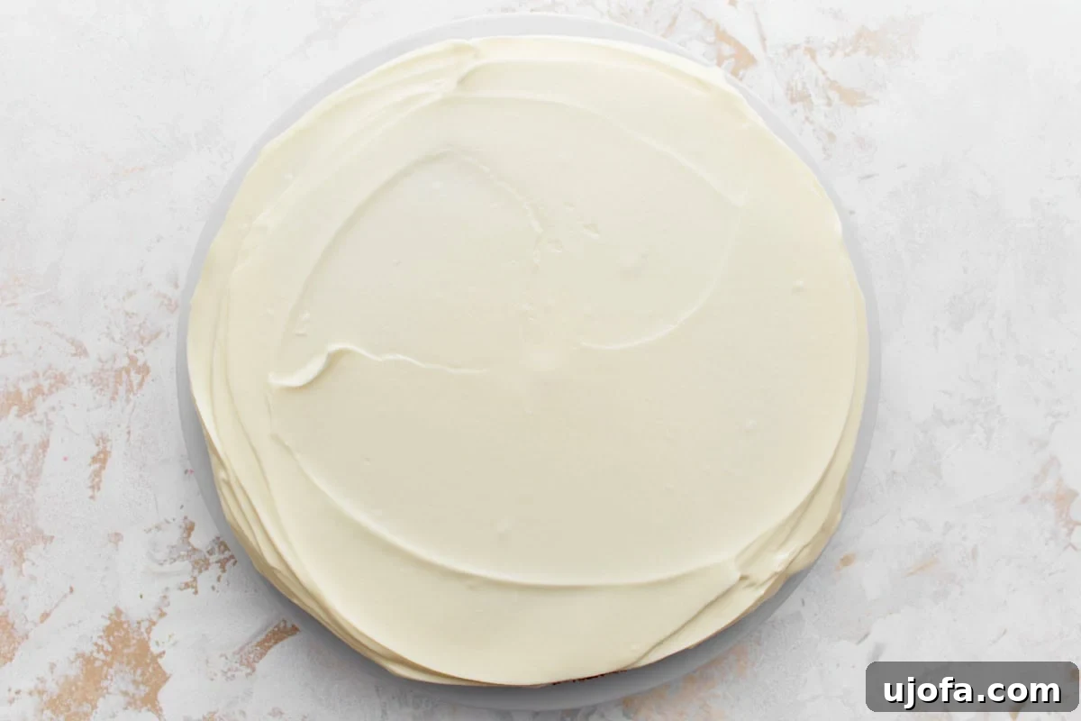 Cake layer frosted with smooth cream cheese frosting
