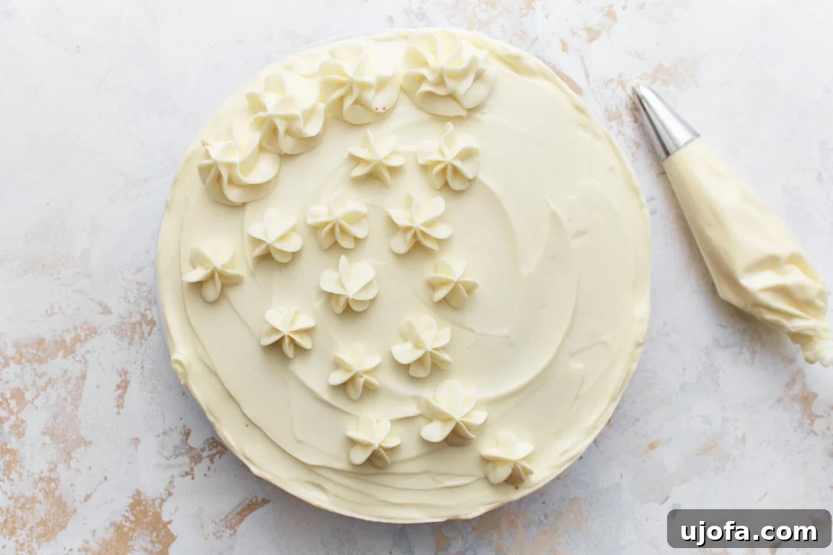 A gluten-free red velvet cake with cream cheese frosting and piped flower decorations