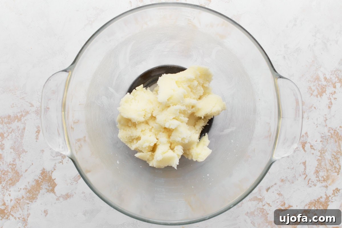 Butter and sugar creamed together in glass mixing bowl