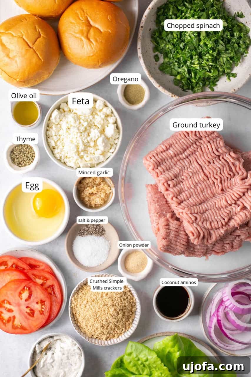 A vibrant selection of fresh ingredients laid out, including lean ground turkey, crumbled feta cheese, fresh spinach, a single egg, and various herbs and spices, essential for crafting delicious air fryer turkey burgers.