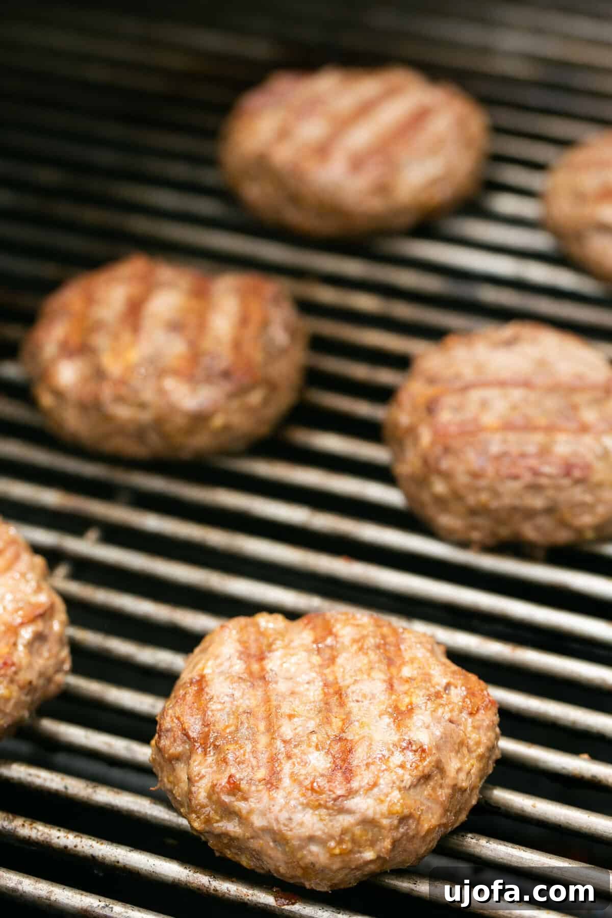 a photo of burger patties grilling on a bbq