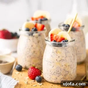 Protein Power Overnight Oats 6 protein overnight oats in mini glass jars on a wooden cutting board topped with fruit
