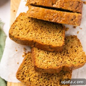 gluten free zucchini bread sliced up on a cutting board with parchment paper