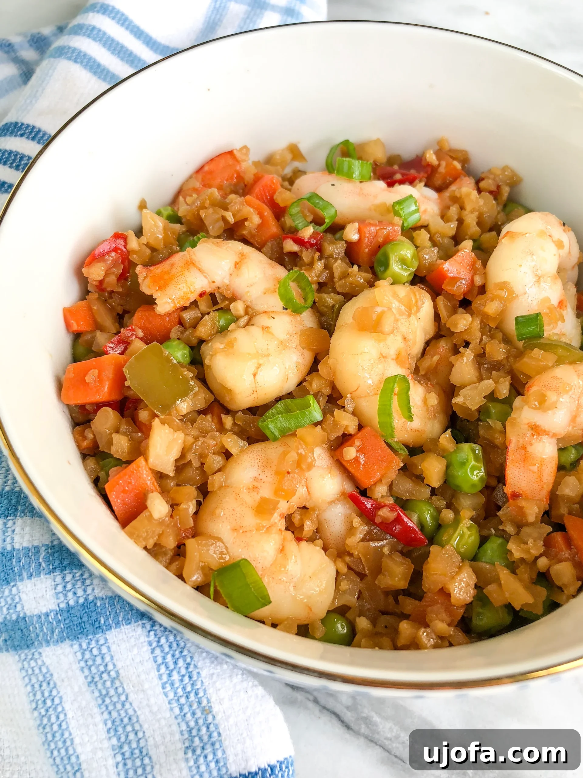 Savory Paleo Shrimp Cauliflower Fried Rice 3 Close-up of Paleo Shrimp Fried Rice with scrambled egg and vegetables.