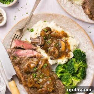 Instant Pot Steak with homemade gluten free gravy on a plate with mashed potatoes and broccoli