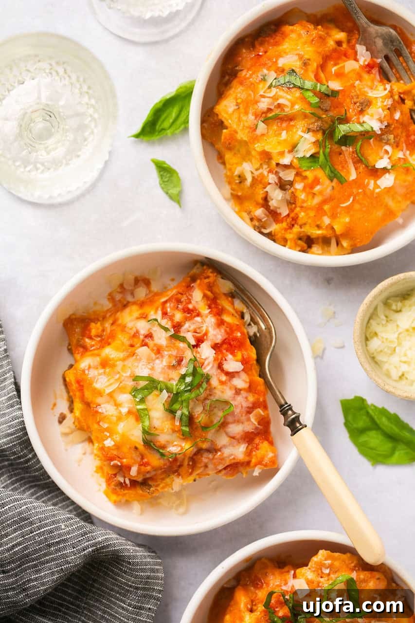 An overhead shot of three white bowls filled with generous slices of Instant Pot lasagna featuring gluten-free noodles, garnished with fresh basil.