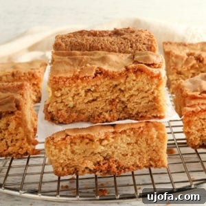 Gluten-free blondies stacked on top of each other on a cooling rack