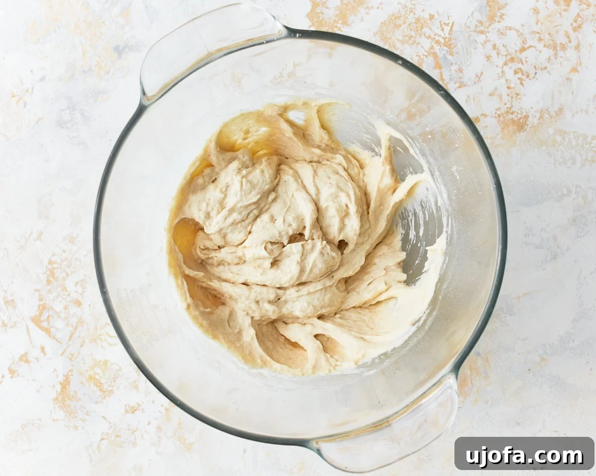 Artisan Gluten-Free Focaccia 6 wet gluten-free focaccia dough in a glass bowl.