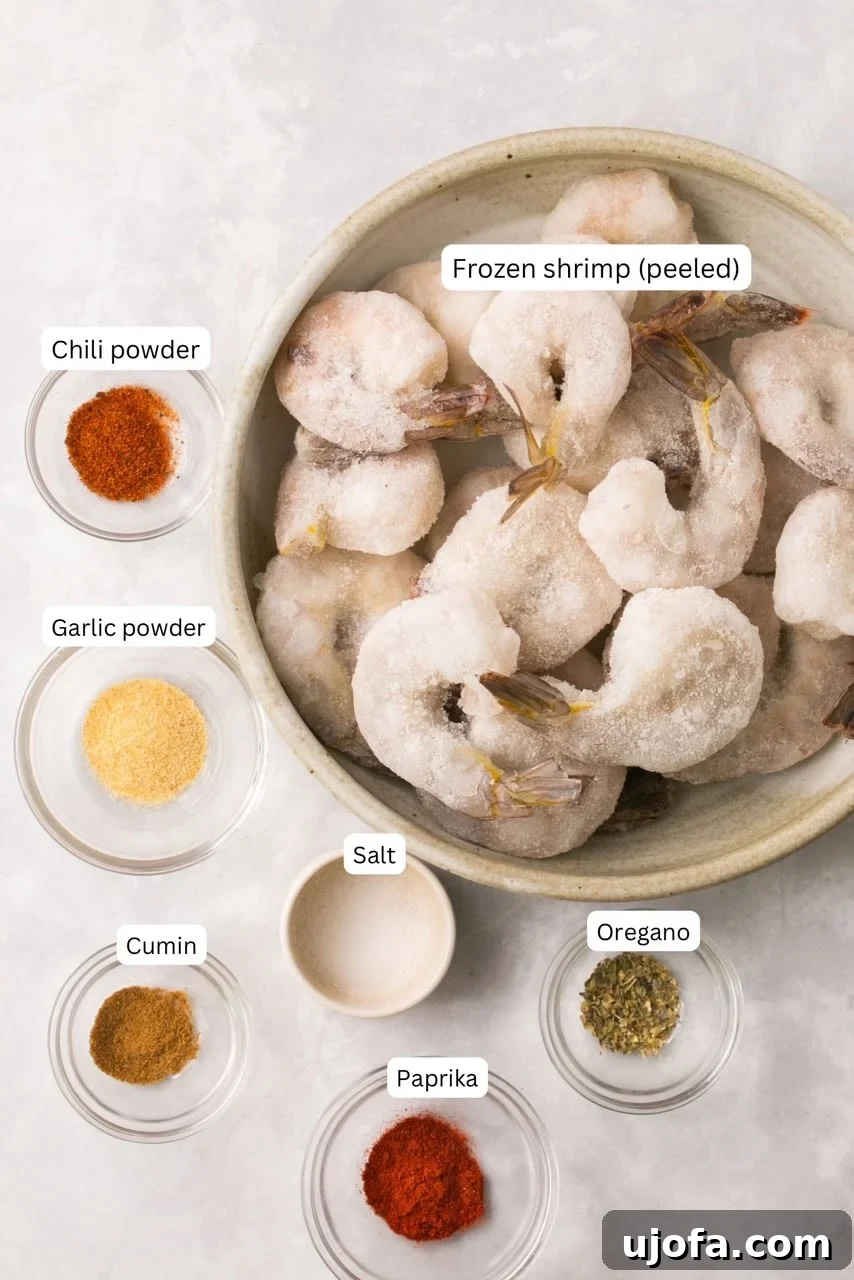 Close-up of frozen shrimp seasoned in an air fryer basket.