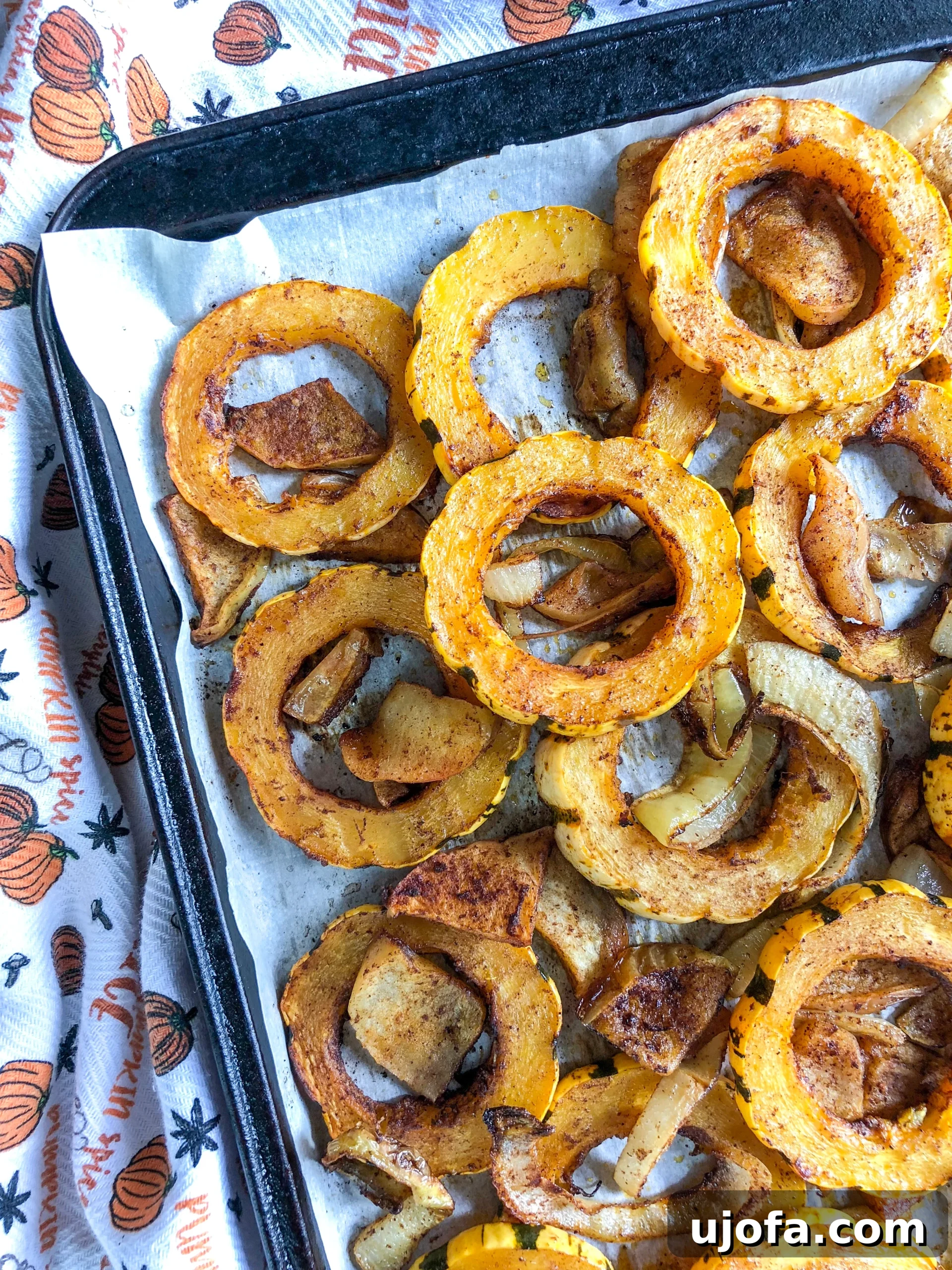 Roasted Delicata Squash Slices with Apples and Onions on a Baking Sheet, ready to be served