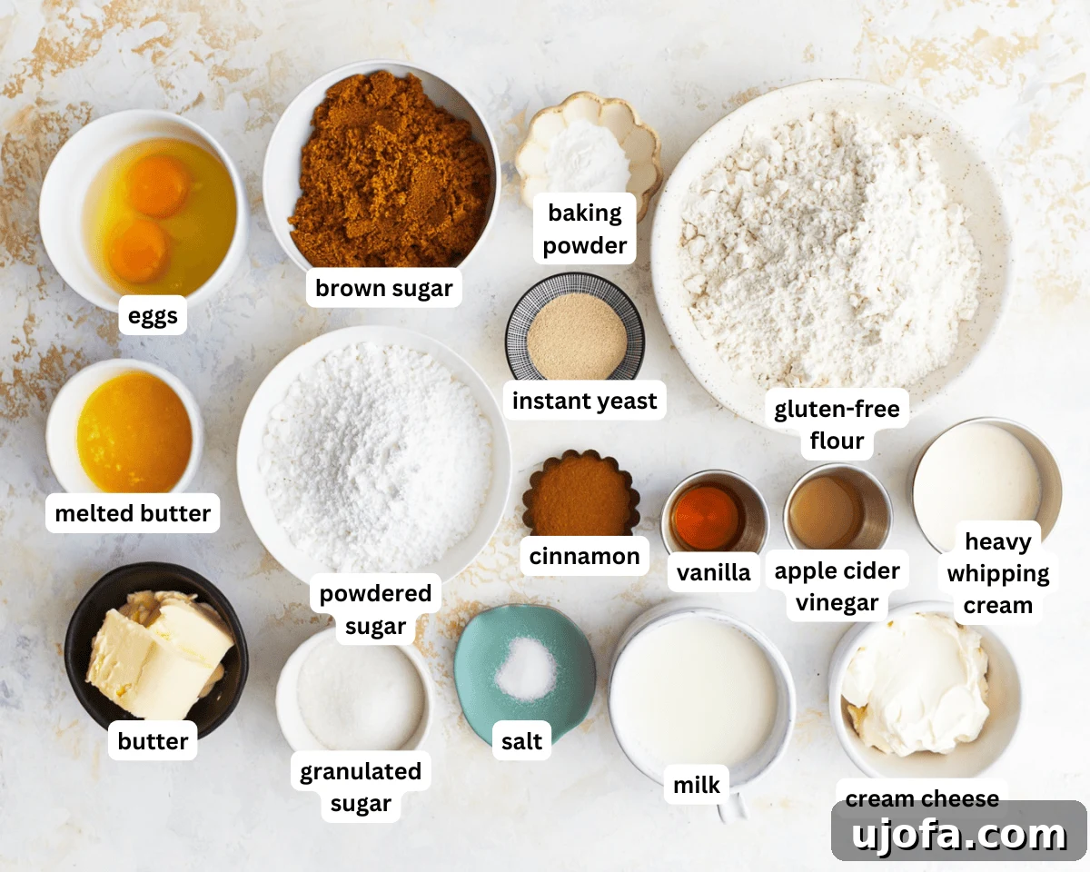 Irresistible Gluten-Free Cinnamon Buns 4 A collection of ingredients for gluten-free cinnamon rolls neatly arranged on a white surface, including flour, sugar, butter, eggs, milk, yeast, and spices.