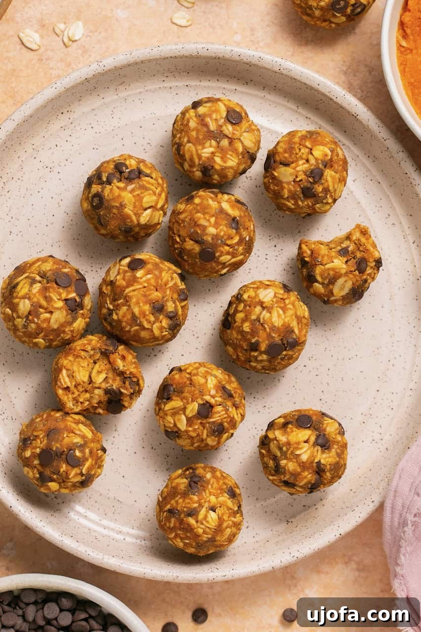 A stack of pumpkin pie bliss balls on a white plate