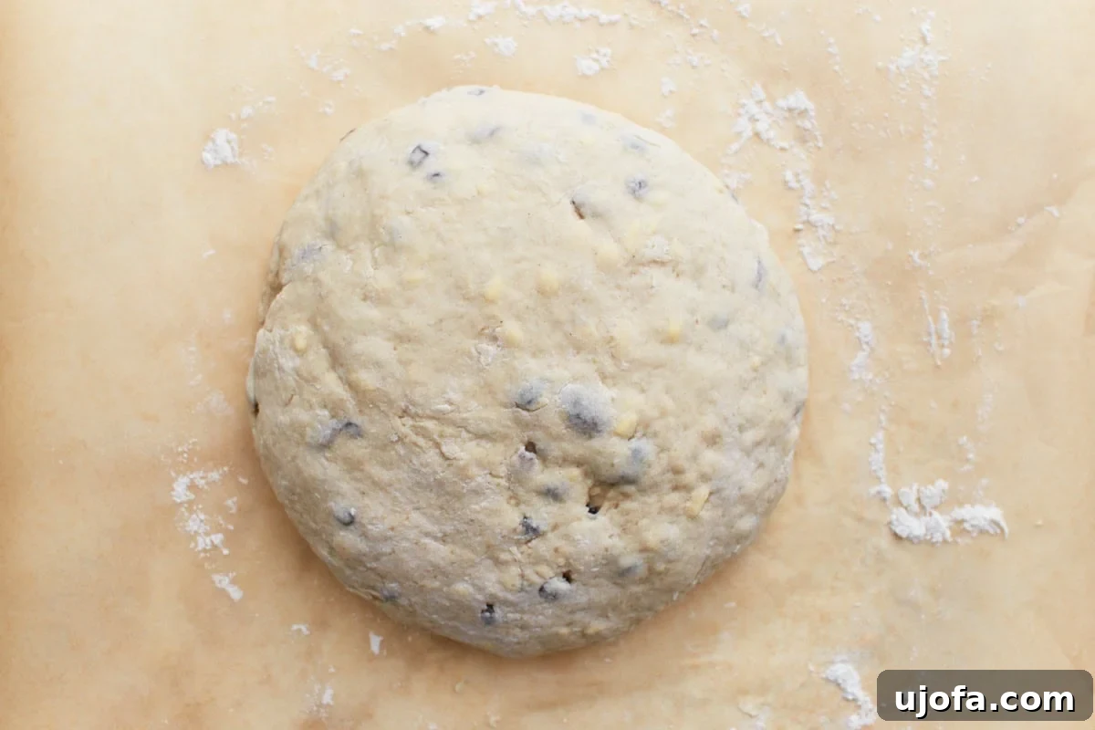 Deliciously Simple Gluten-Free Irish Soda Bread 11 A rounded dough ball sprinkled with flour on parchment paper, ready for shaping