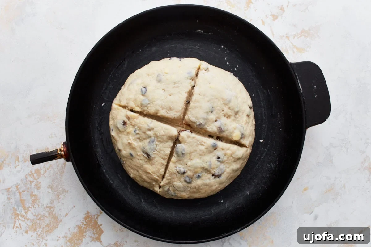 Deliciously Simple Gluten-Free Irish Soda Bread 15 The dough in a cast iron skillet with a deep cross scored on the top, prepared for the oven