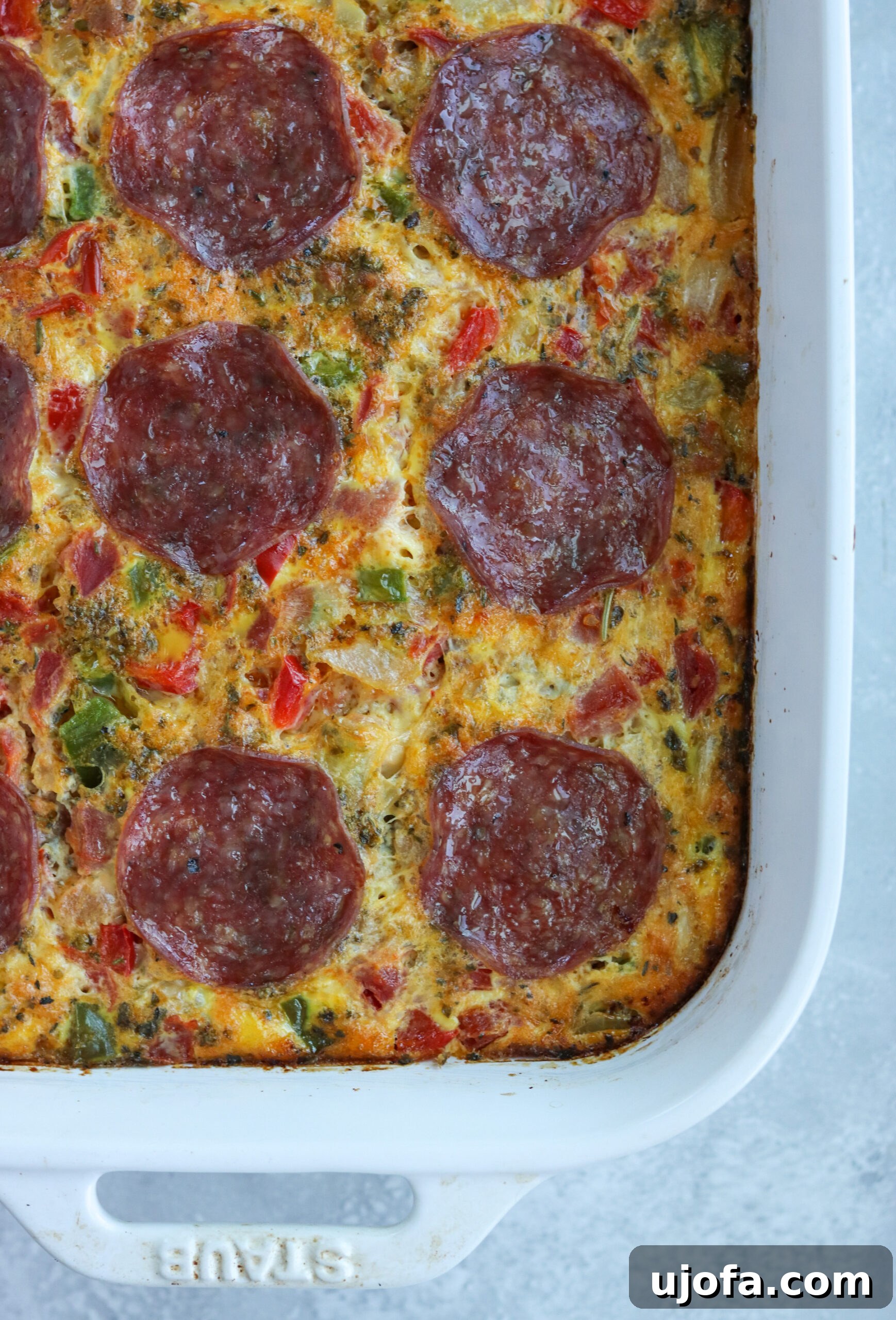 Delicious Paleo Pizza Breakfast Casserole with Italian sausage, peppers, onions, tomatoes, and pepperoni