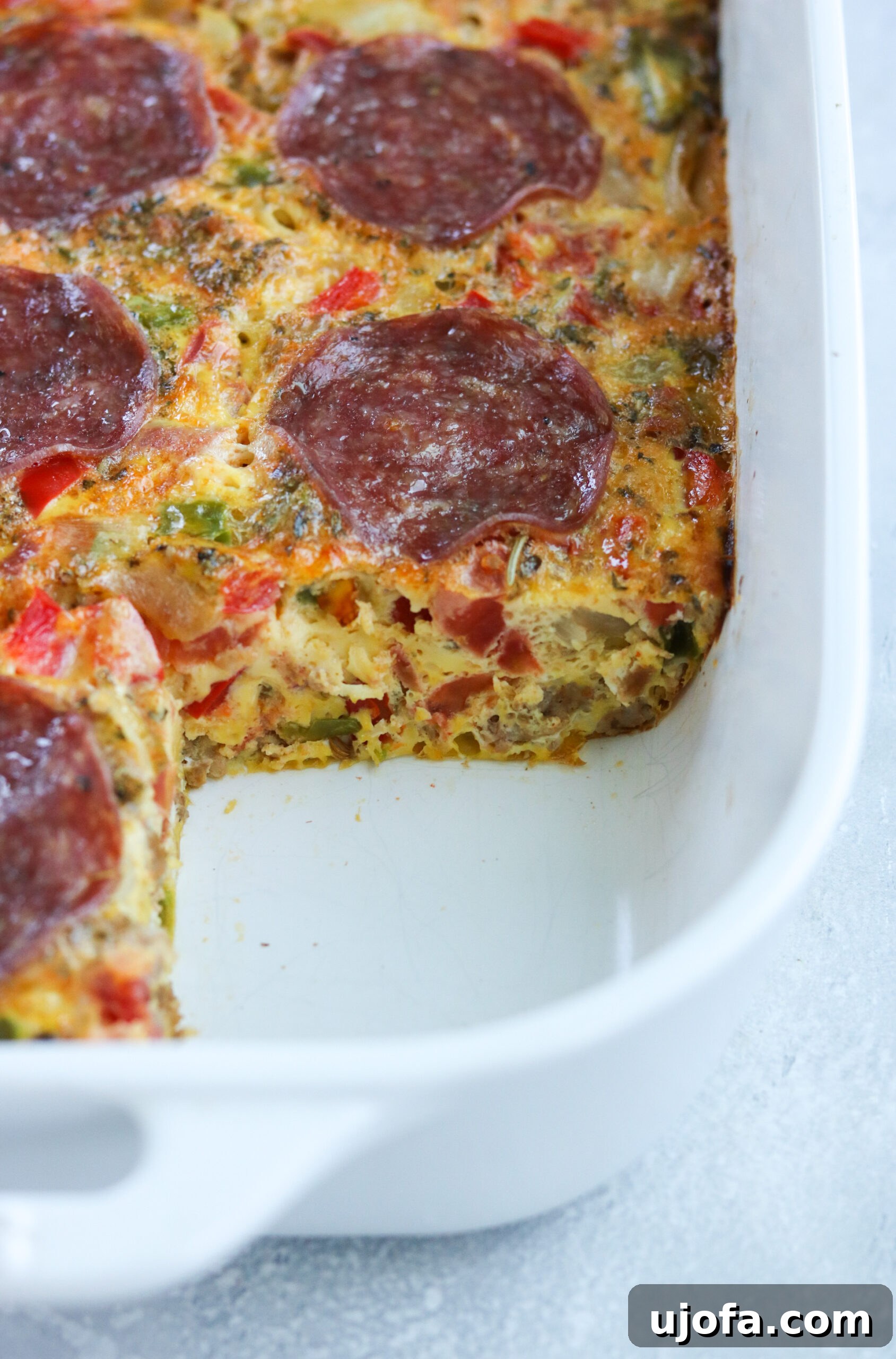 Close-up of baked Paleo Pizza Breakfast Casserole showcasing the golden eggs and vibrant toppings