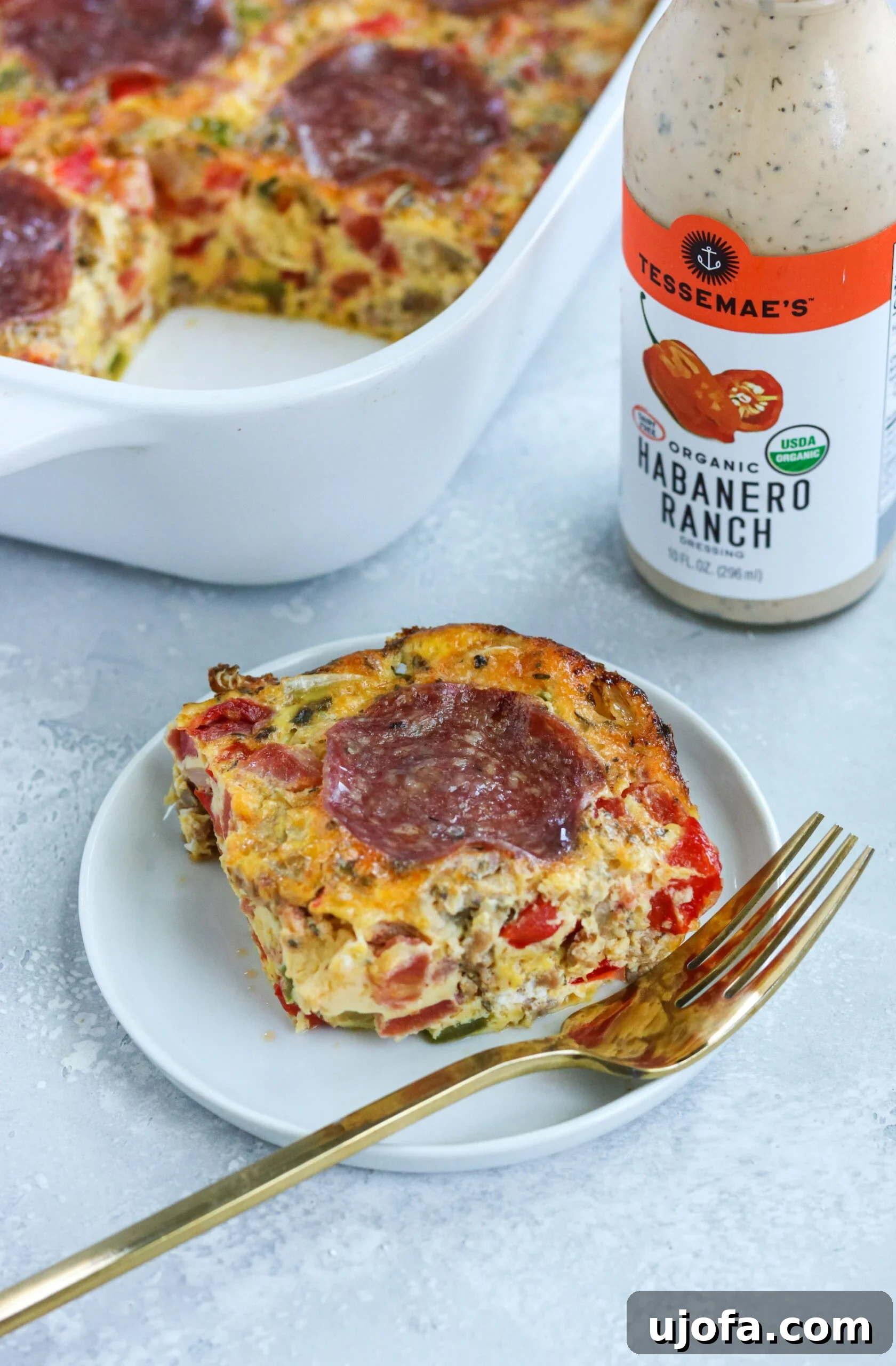 Portion of Paleo Pizza Breakfast Casserole with a drizzle of ranch dressing, ready to eat