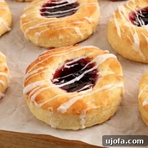 Gluten-free Danish pastries topped with jam on white parchment paper