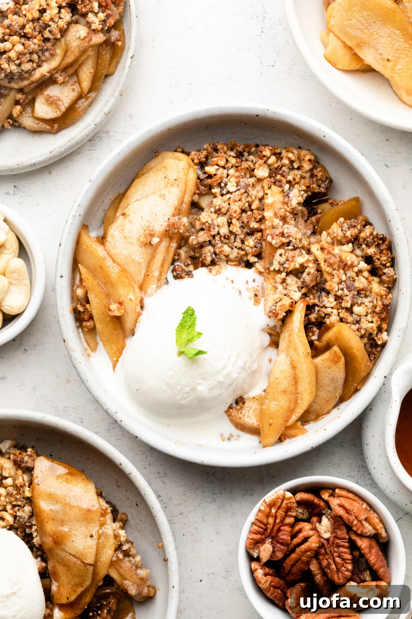 Delicious Paleo Apple Crisp served in a bowl with dairy-free ice cream