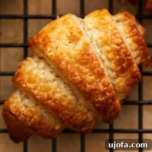 Gluten Free Brunch Delights 13 A perfectly golden-brown gluten-free croissant rests on a black cooling rack, showcasing its flaky layers.