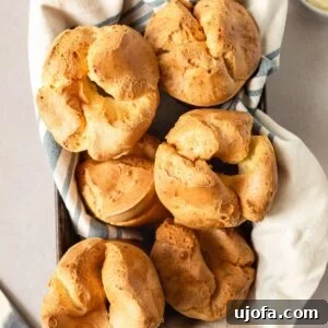 Gluten Free Brunch Delights 18 An overhead close-up shot of freshly baked popovers nestled in a towel-lined baking pan, showcasing their impressive puff and golden-brown exterior.