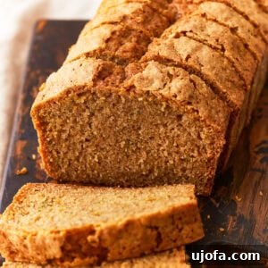 Gluten Free Brunch Delights 53 A freshly baked gluten-free zucchini bread, beautifully sliced and arranged on a rustic wood cutting board, showcasing its moist interior.