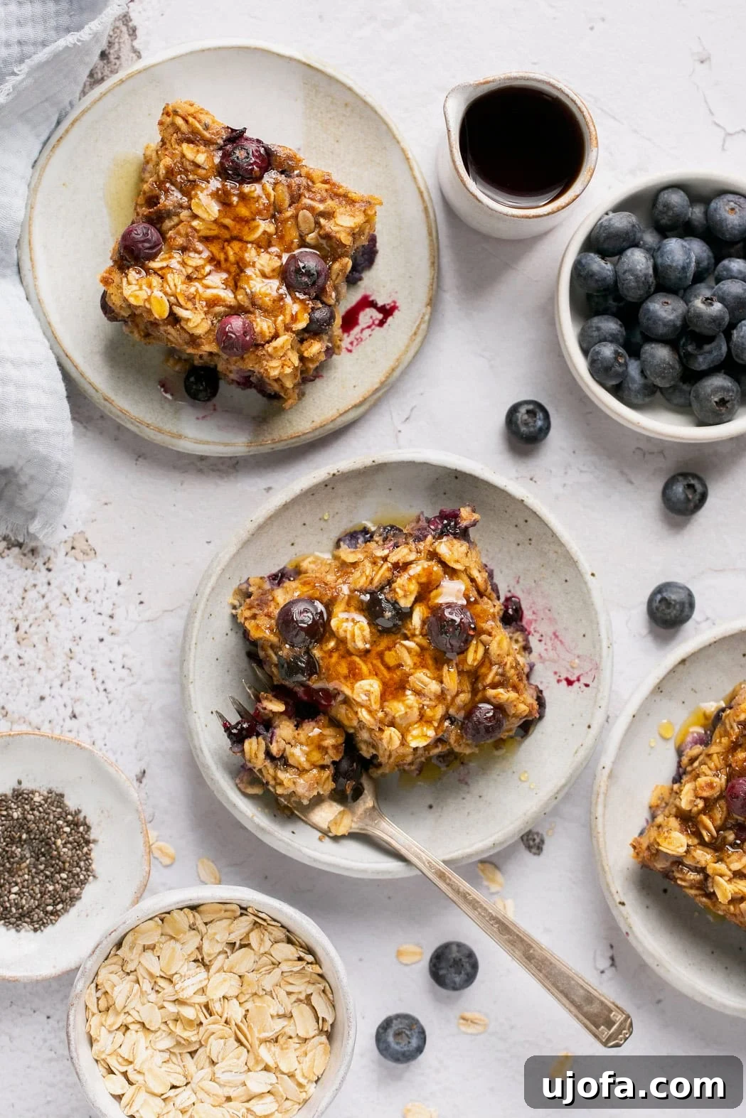 An overhead shot of a plate with a slice of baked oatmeal and a fork resting on the side, ready to eat