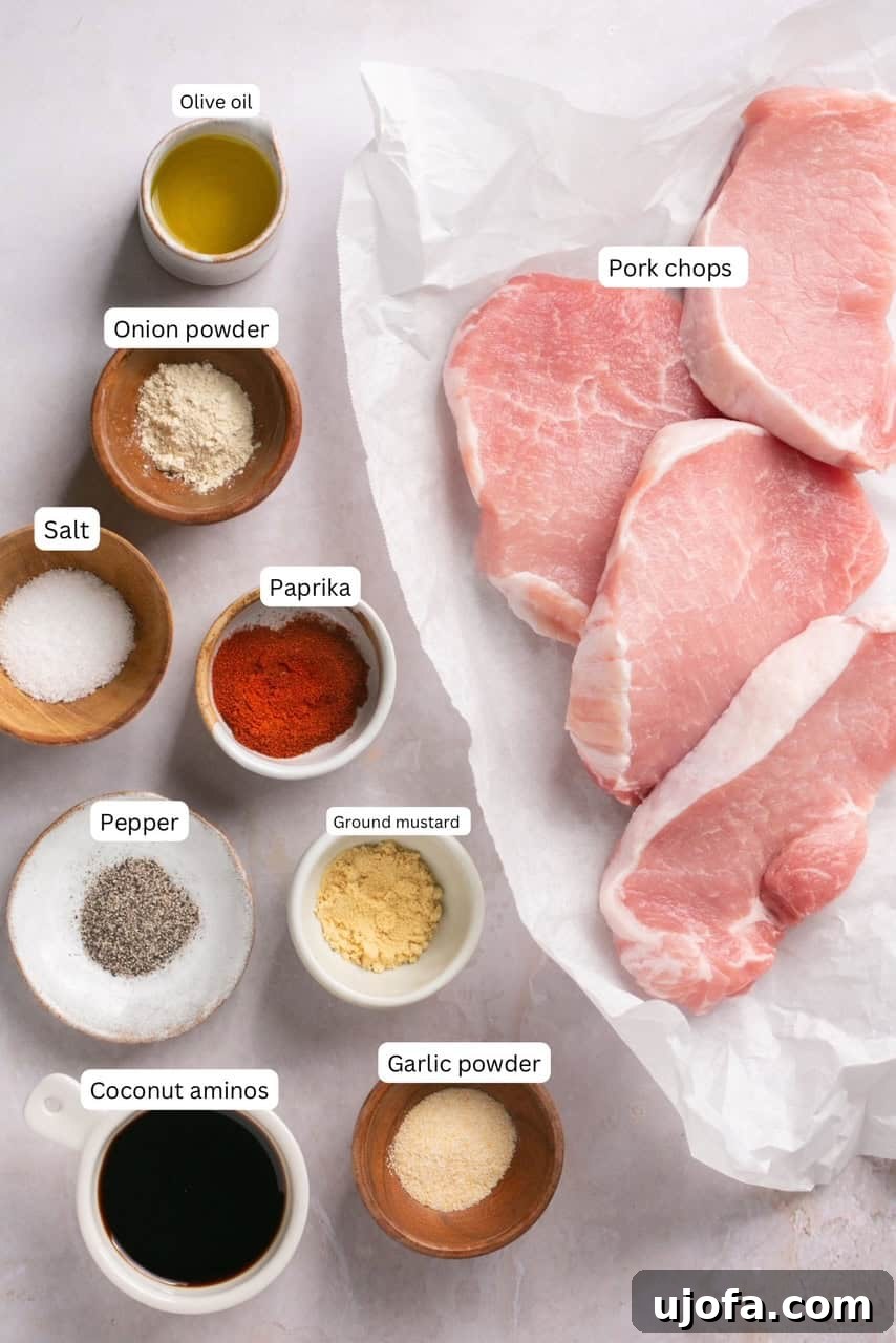 Crispy Air-Fried Pork Chops 3 Labeled recipe ingredients in nesting bowls, including olive oil, coconut aminos, and various spices.