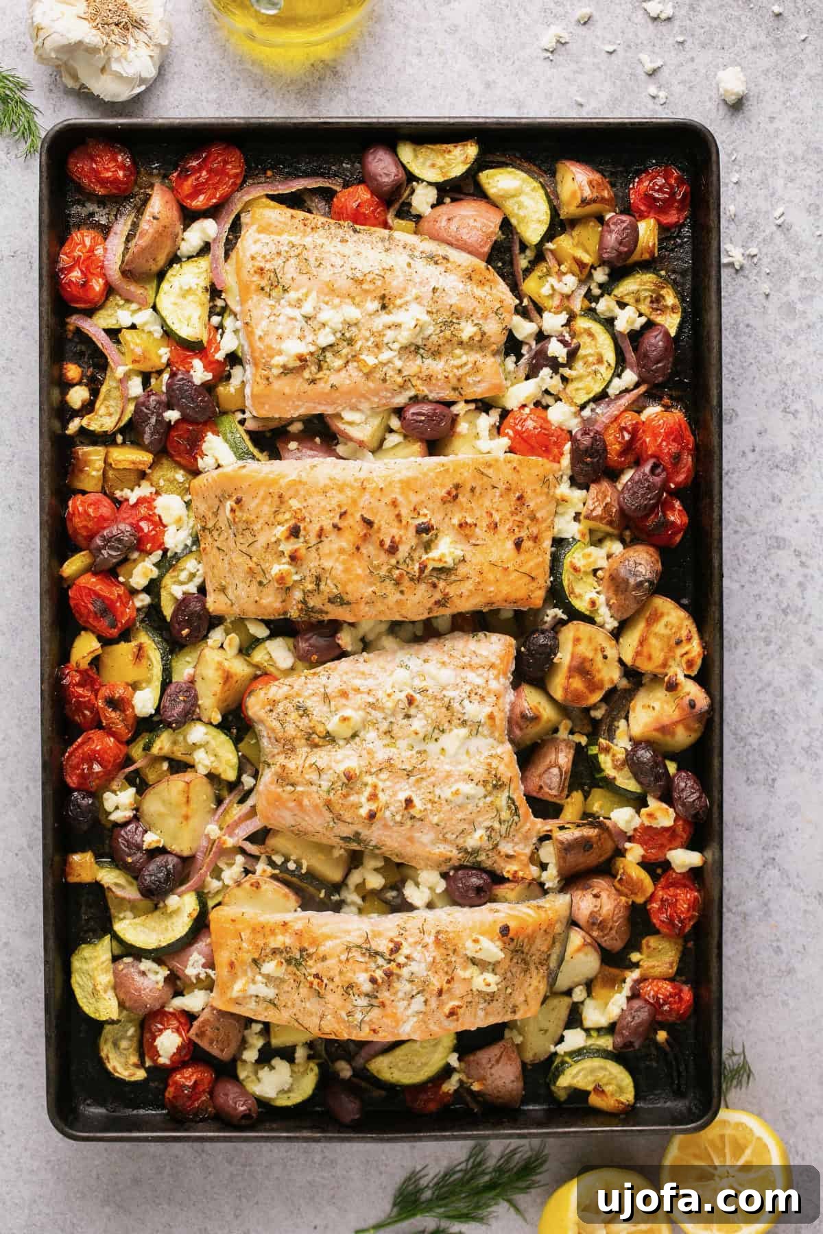 One Pan Greek Salmon with Roasted Vegetables 6 sheet pan salmon and vegetables with Greek Marinade and feta on a sheet pan