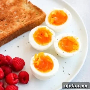 air fryer soft boiled eggs on a plate with toast and raspberries