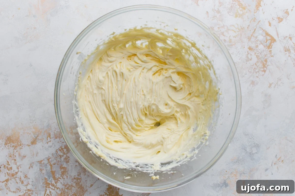Bowl of smooth, fluffy cream cheese frosting after mixing.