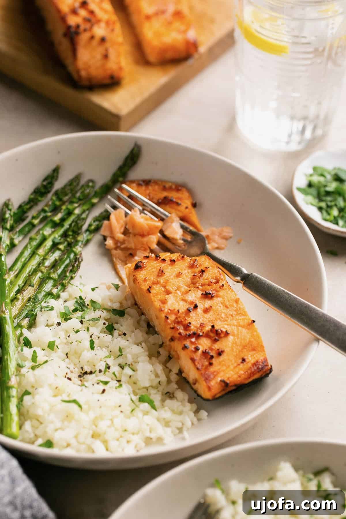 Effortless Air Fryer Salmon Straight From Frozen 7 A close-up shot of a fork gently flaking a piece of perfectly cooked air fryer salmon, showcasing its tender, moist texture.