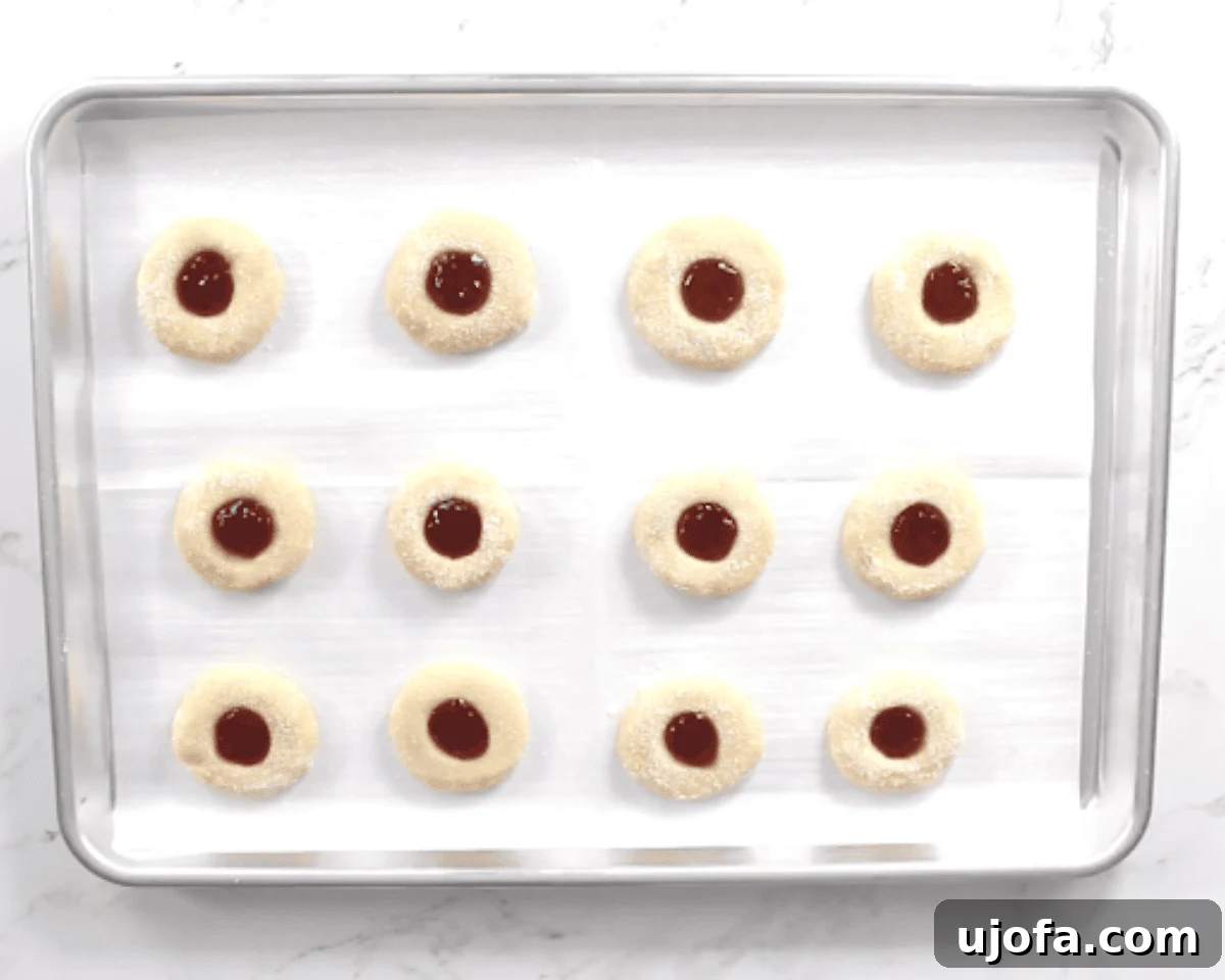 gluten-free thumbprint cookies on a cookie sheet before going into oven