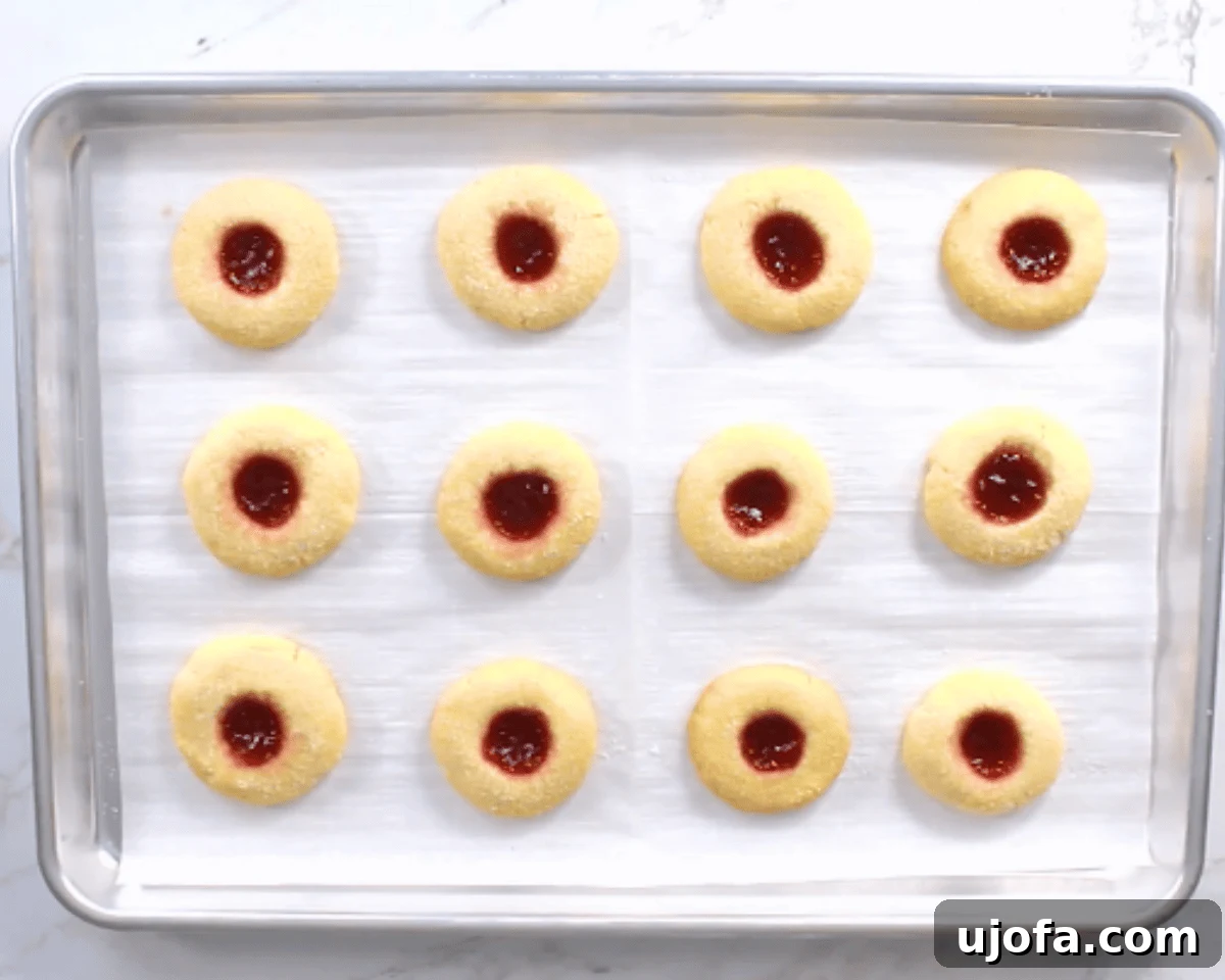 gluten-free thumbprint cookies on a cookie sheet before going into oven