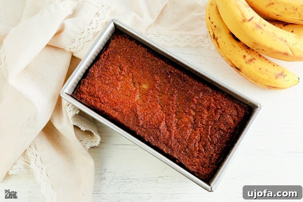 Almond flour banana bread in a baking pan, ready to be sliced