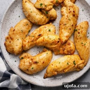 air fryer chicken tenderloins on a plate with a black and white checkered napkin underneath