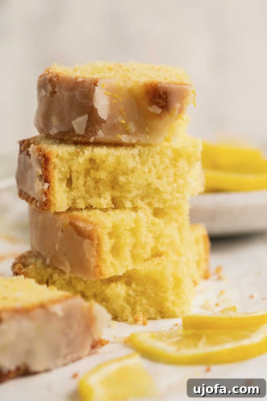 Zesty Gluten-Free Lemon Drizzle Cake 7 4 pieces of lemon drizzle cake stacked on top of each other