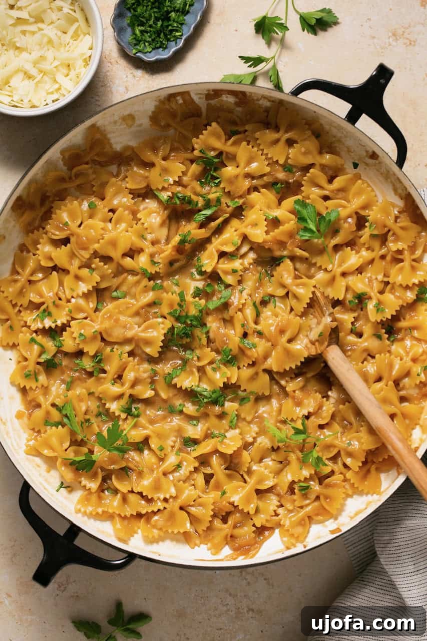 TikTok's Must-Try Gluten-Free French Onion Pasta 2 A pot of creamy French onion pasta topped with fresh green parsley, ready to be served.