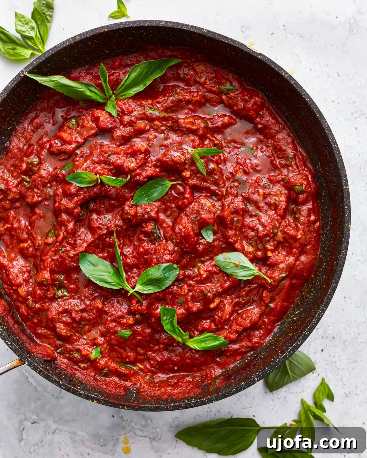 A skillet of vibrant gluten-free spaghetti sauce simmering on the stovetop.