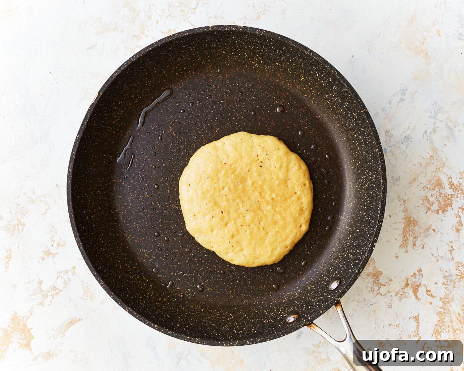 Fluffy Almond Pancakes 8 Almond flour pancake batter poured into a frying pan.