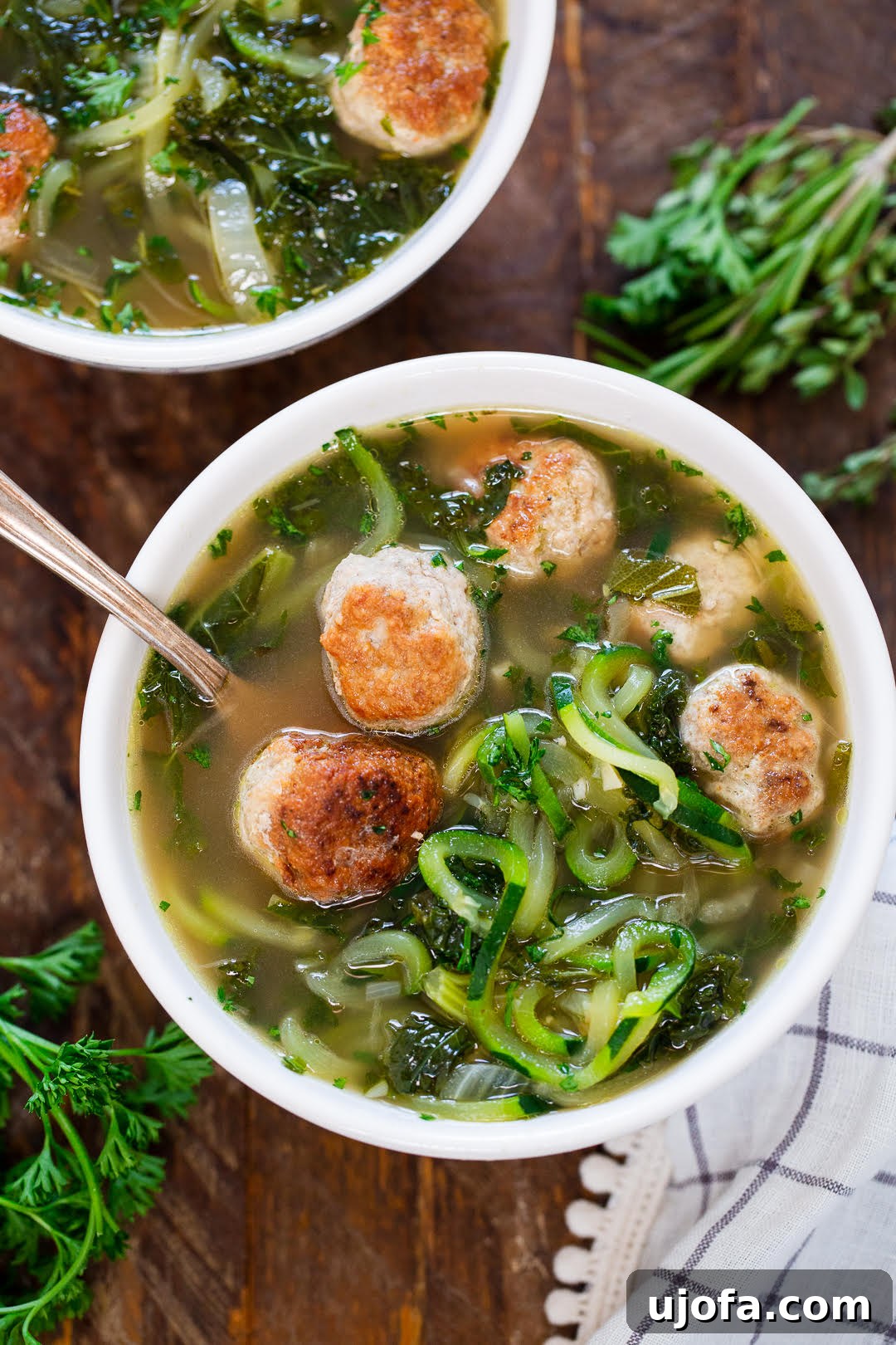 A comforting bowl of Paleo Turkey Meatball and Zoodle Soup, featuring tender meatballs and spiralized zucchini noodles.