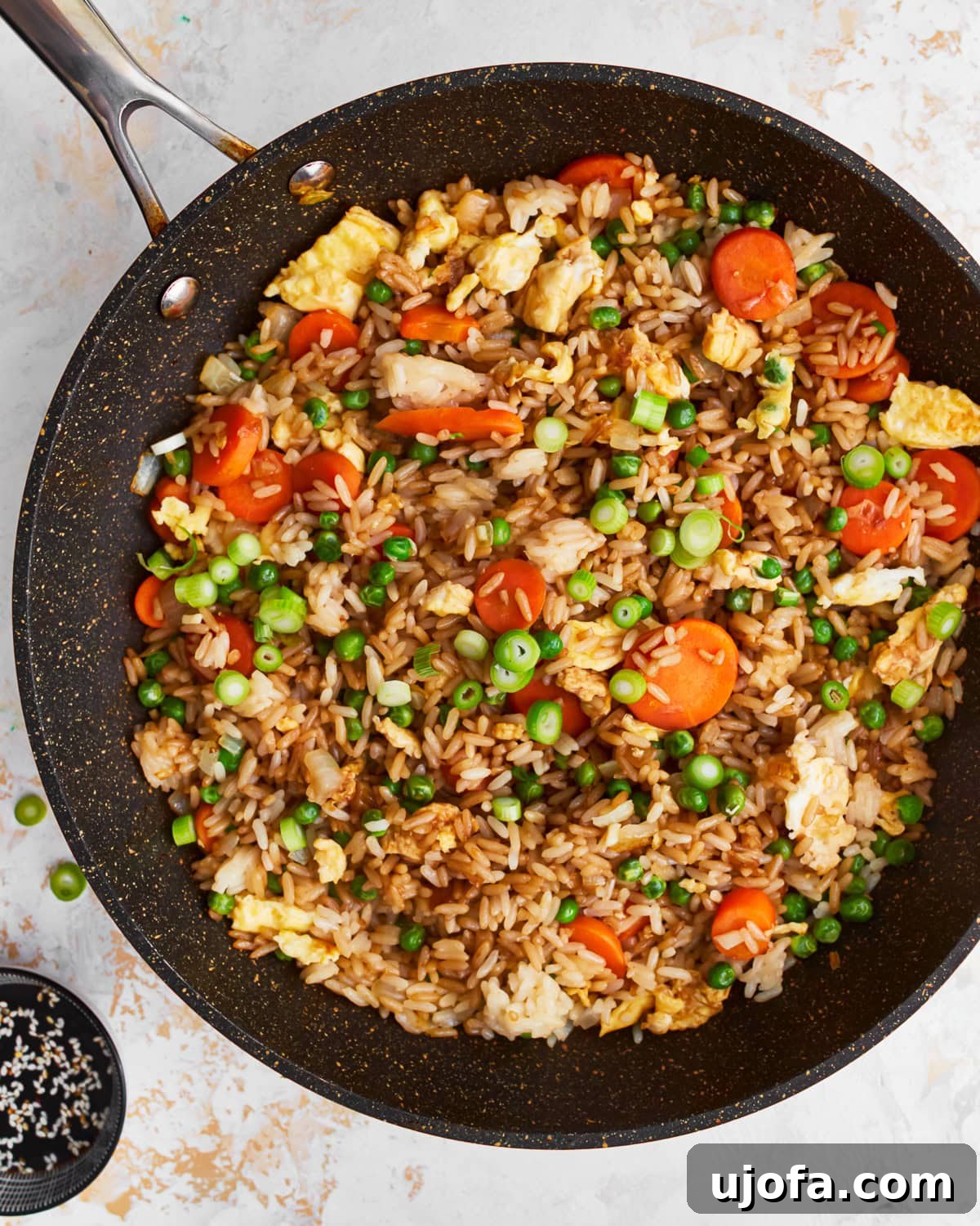 Your New Favorite Gluten-Free Fried Rice 2 Gluten-free fried rice in a skillet, showcasing a vibrant mix of rice, eggs, and vegetables.
